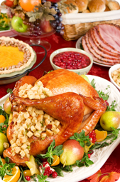 Turkey on table surrounded by holiday food