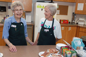 Senior women helping in the kitchen