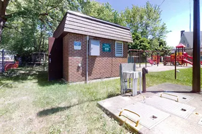 Fares Street Sewage Pumping Station located next to a park on a sunny day