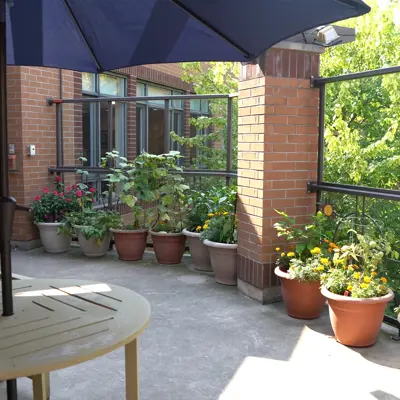 An outdoor seating area at Woodlands of Sunset with plants