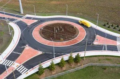 The roundabout is surrounded by fields and trees