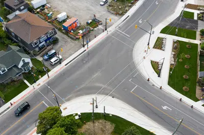 The new parkette is surrounded by buildings and a parking lot