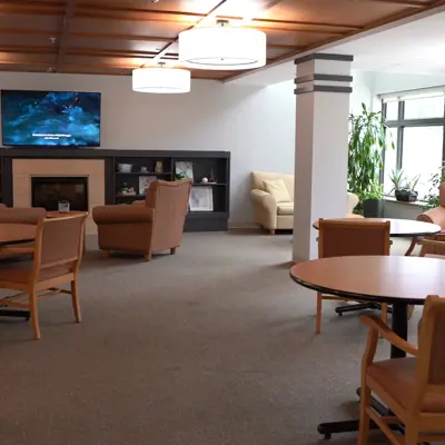 A recreation area at Deer Park Villa featuring tables and chairs and a television