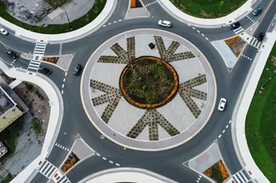 The completed roundabout has signage and flowers and other plants in the centre