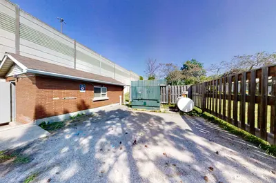 Rolling Acres Sewage Pumping Station from the outside, showing the building itself and the fence