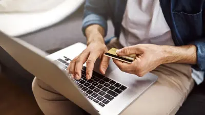 Man making a payment on his laptop using a credit card