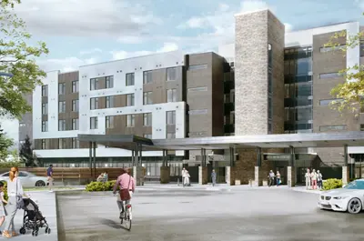 The facility is a large grey-brick building with a paved area out front and large glass windows