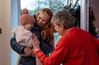 Mother and daughter visiting an elderly family member