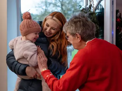Mother and daughter visiting an elderly family member