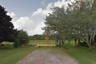 End of Livingston Avenue (Regional Road 512) in Grimsby. A yellow safety barrier separates the end of the road from a grassy area.