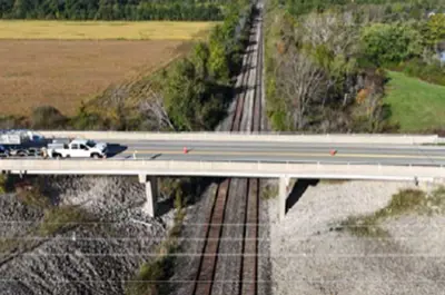 A truck drives across the Wilhelm Road Bridge over train tracks