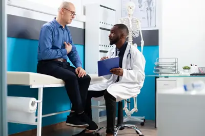 Doctor with clipboard listens to a patient in a doctor's office.