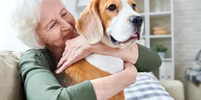 Older woman hugging a dog