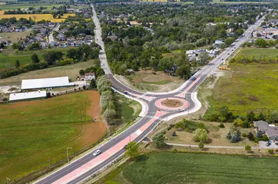 The roundabout at Highway 20 and Townline Road in West Lincoln branches off in three directions. It's surrounded by grass and the town.