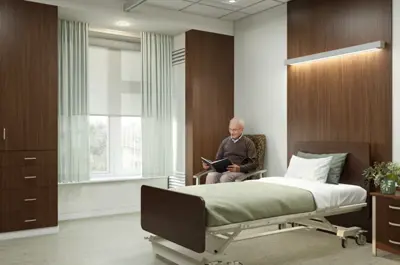 A rendering of an elderly man seated in a residence room beside a bed and next to a window