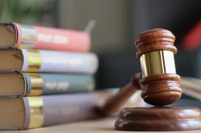 Stacked legal books behind a gavel