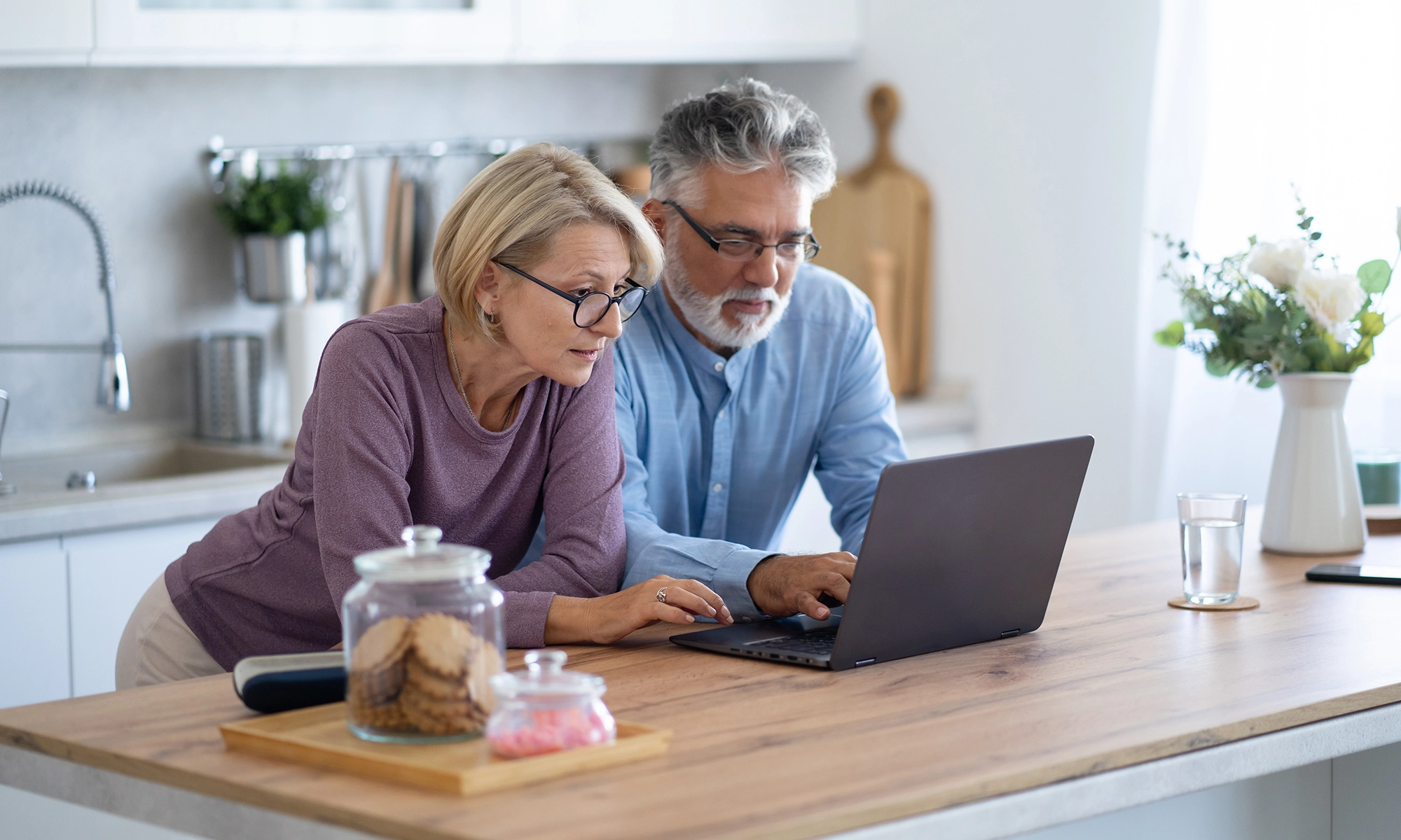 Couple looking at a laptop.