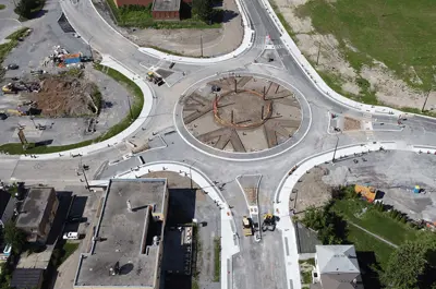 Victoria Avenue Bridge Street intersection in Niagara Falls during construction in August 2022 with the center of roundabout being designed. Arrows pointing from each of the five roads leading into the roundabout are part of the circle