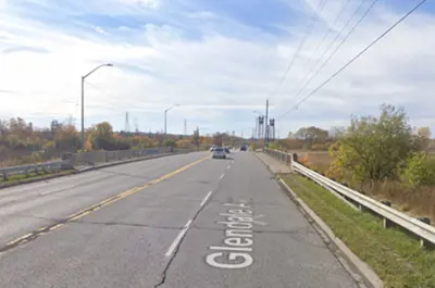 Glendale Avenue looking west at the Glendale Avenue Bridge. There are cars on the road