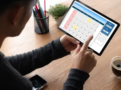 Man looking at a calendar on a tablet
