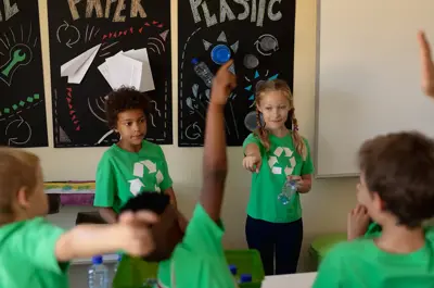 Kids in a classroom completing a recycling exercise.