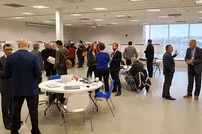 Residents talk to each other at the Public Information Centre