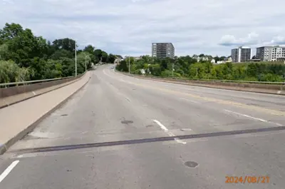 A view on the Twelve Mile Creek Bridge facing some high-rise buildings and trees