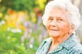 Close-up of an older woman outside in a garden