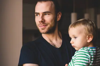 A father holds a young child